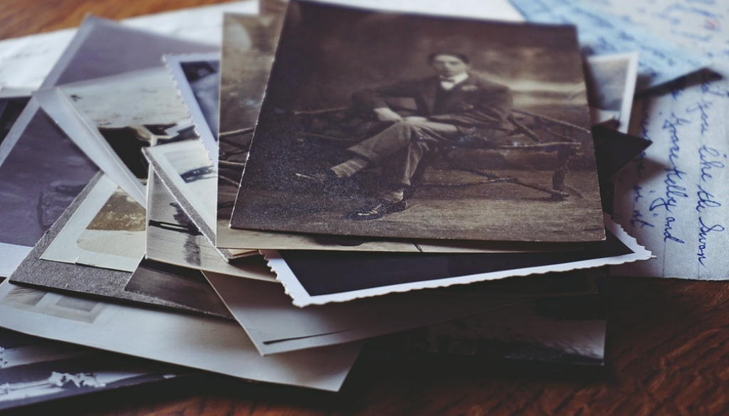 A stack of old black and white photographs