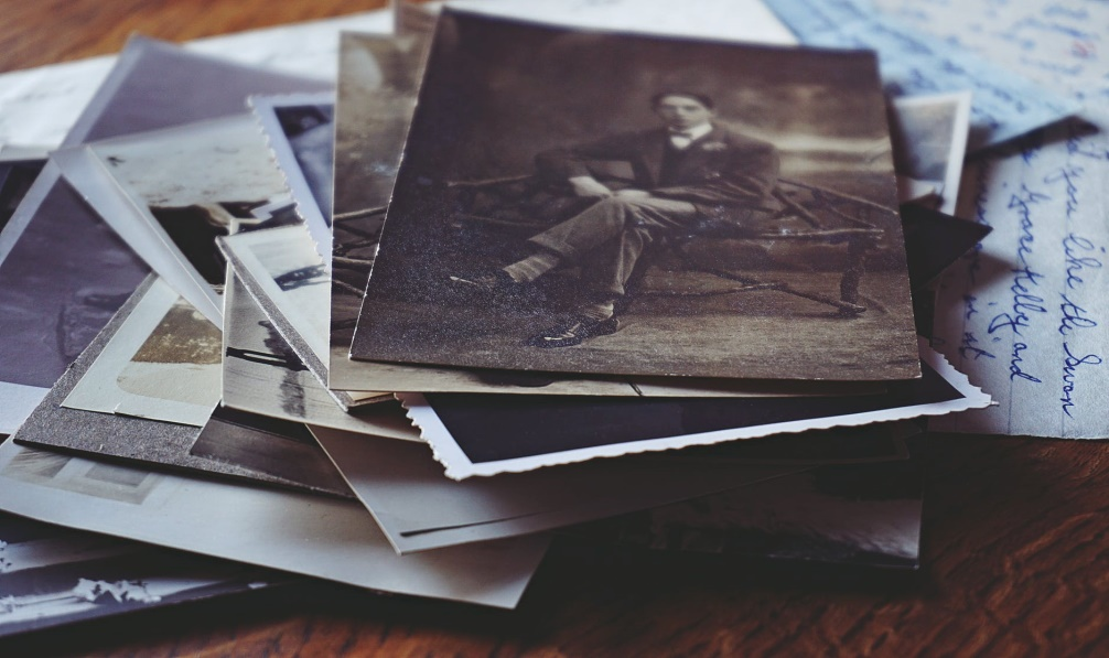 A stack of old black and white photographs