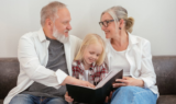 Grandparents are reading a story to a kid