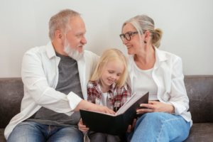 Grandparents are reading a story to a kid