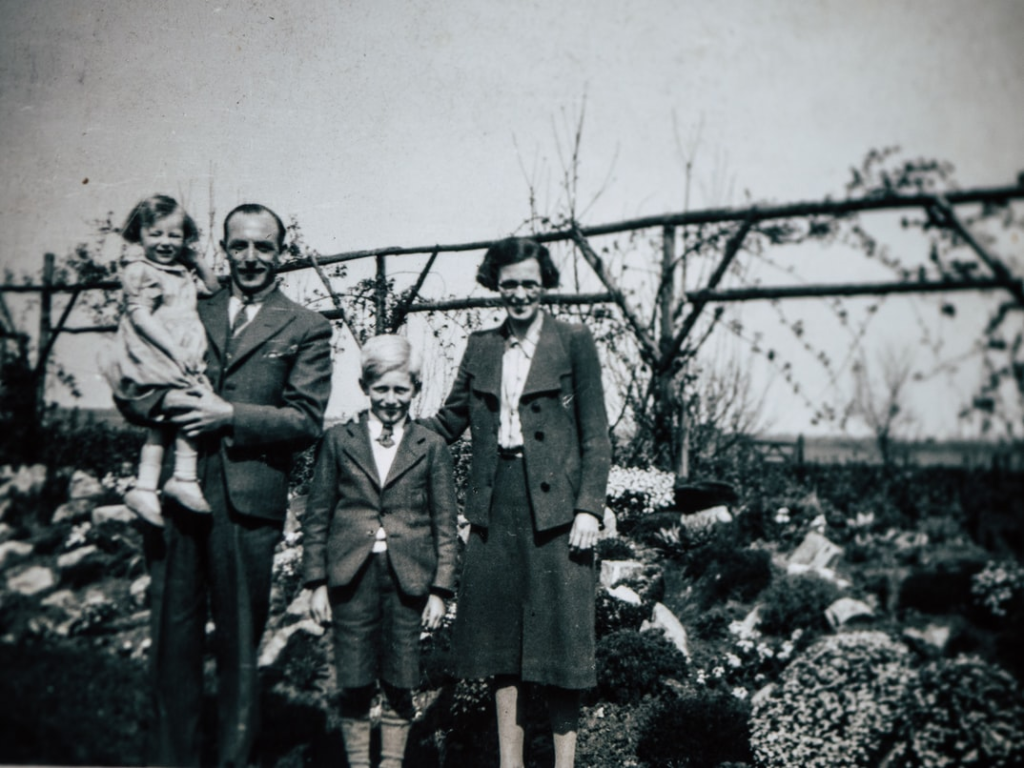 An old black and white family photo of four