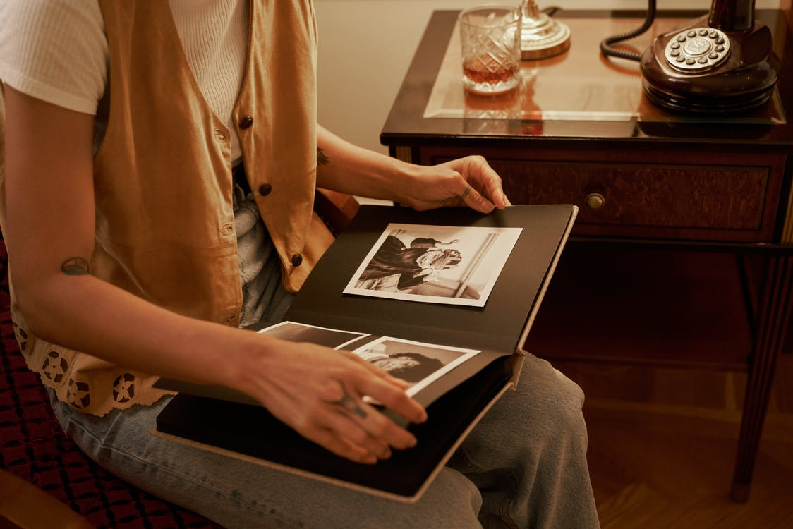 Person looking at an old photo album. 