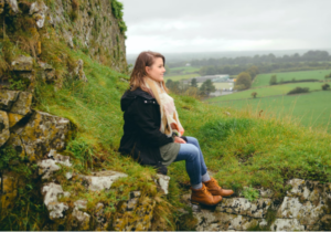 A woman on a trip with a certified genealogist and tour guides.