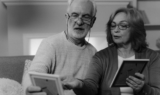 A senior couple looking at Irish family photos