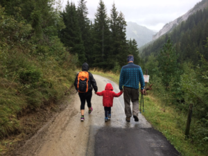 A family walking on the roads of Ireland.