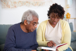  A genealogist reading a document to a person curious about their Irish heritage