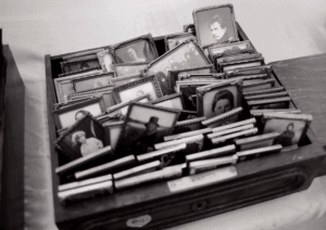 Old framed pictures in a drawer.