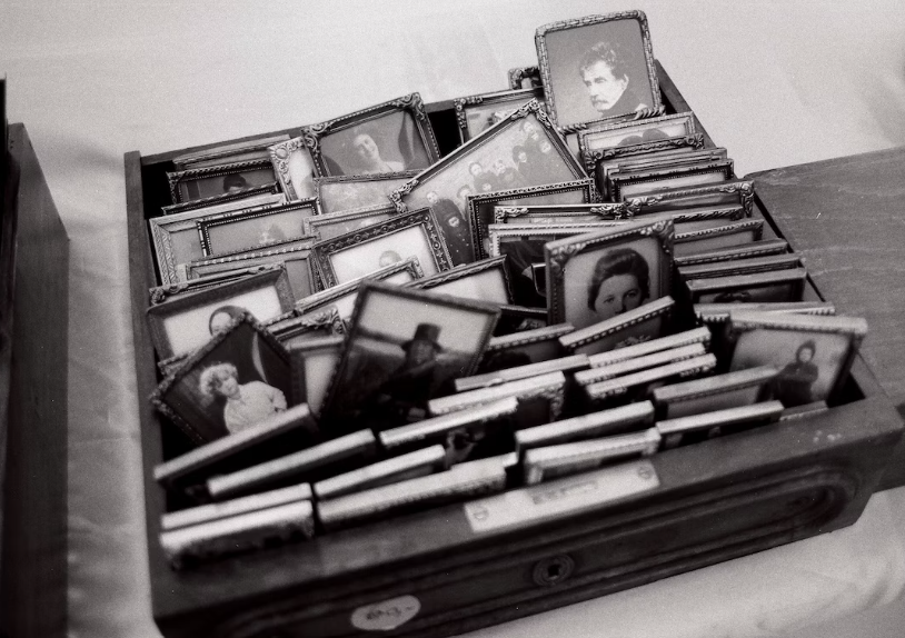 Old framed pictures in a drawer.