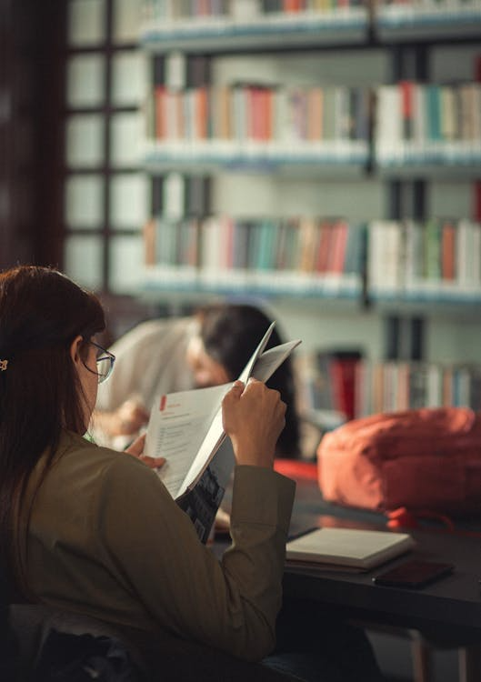 a woman going over a book.