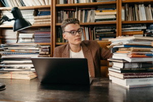 a man in a brown blazer at the library.