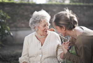 two women sitting outdoors.